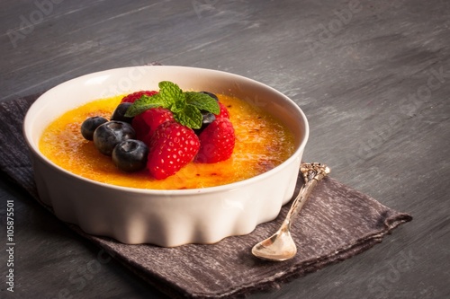 Creme brulee Dessert wih fruits and mint leaves photo