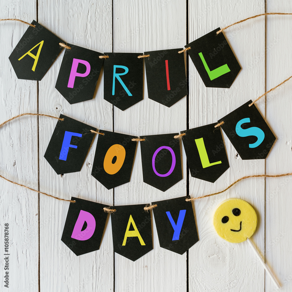 Φωτογραφία April fools day black banner colorful lettering on white barn wood rustic planks background