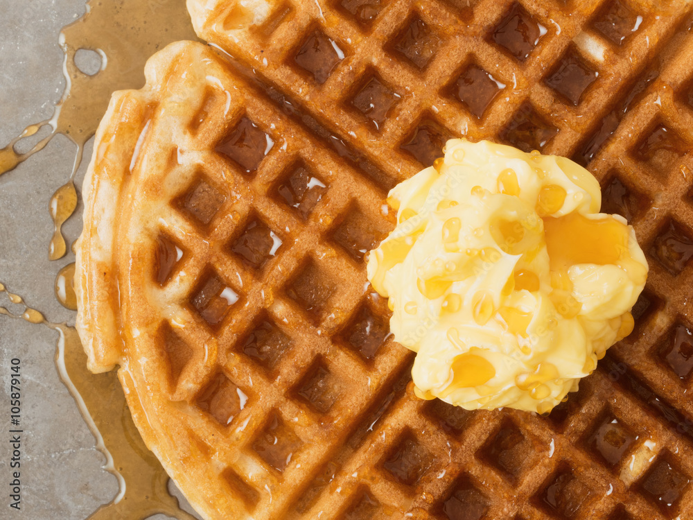 rustic traditional waffle with butter and maple syrup