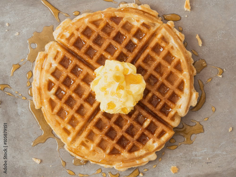 rustic traditional waffle with butter and maple syrup