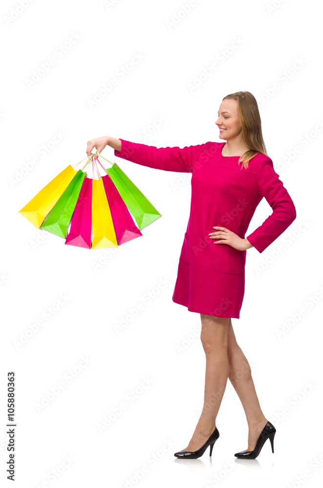 Shopper girl in pink dress holding plastic bags isolated on whit
