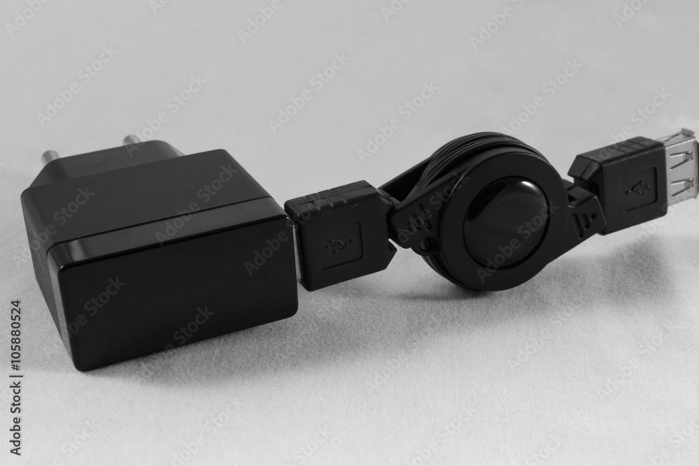 Black Phone Charger and USB cable on white background close-up Black Phone Charger and USB cable on white background close-up