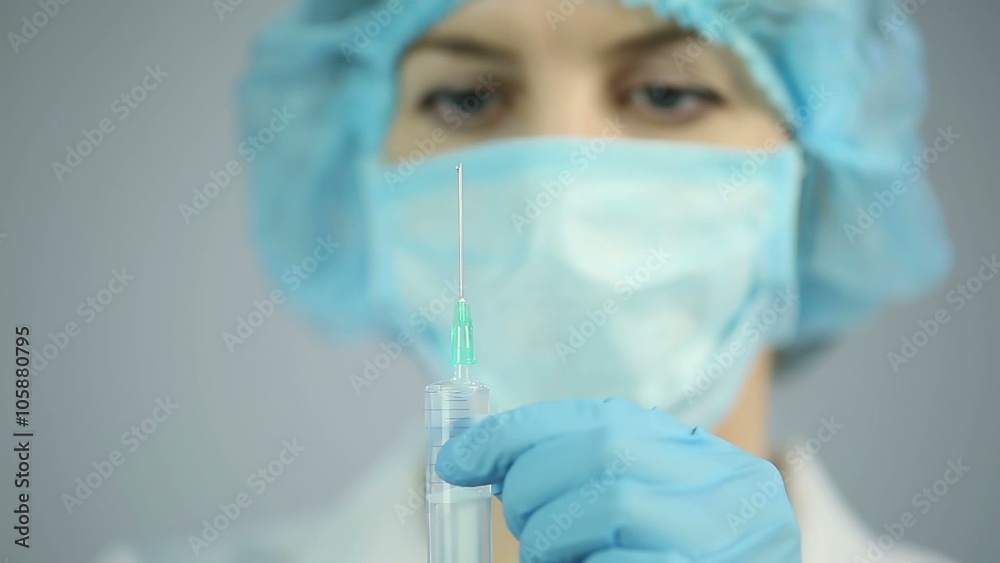 Experienced nurse preparing medical drugs for injection, health care system Experienced nurse preparing medical drugs for injection, health care system