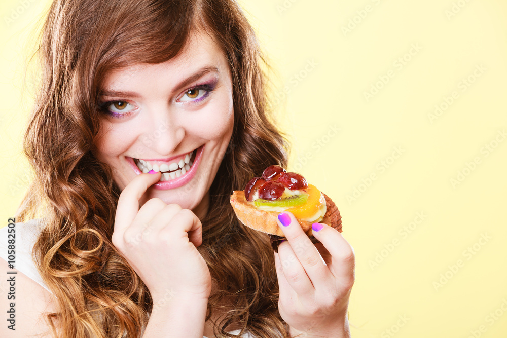 Closeup flirty woman eating fruit cake Closeup flirty woman eating fruit cake