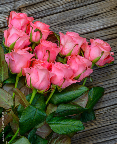 Fototapeta Naklejka Na Ścianę i Meble -  Close up on roses over wooden table