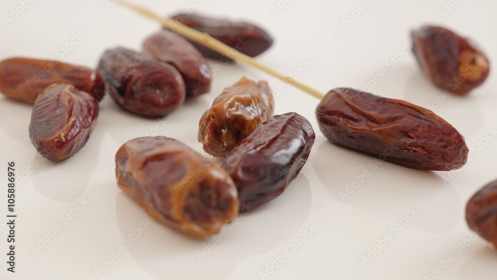Date palm fruit exotic dried fruit on white background slow tilting 4K 2160p UltraHD footage - Phoenix dactylifera fruit on white slow tilt close-up 4K 3840X2160 UHD video Date palm fruit exotic dried fruit on white background slow tilting 4K 2160p UltraHD footage - Phoenix dactylifera fruit on white slow tilt close-up 4K 3840X2160 UHD video