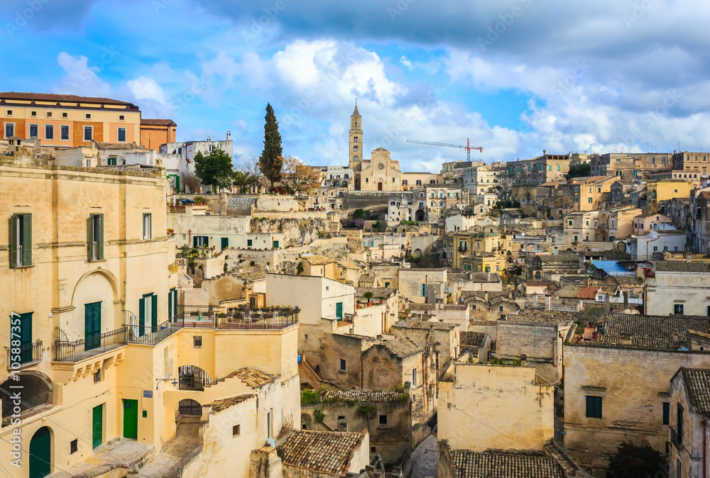 Ancient town of Matera (Sassi di Matera), European Capital of Culture 2019, in beautiful golden morning light with blue sky and clouds, Basilicata, southern Italy