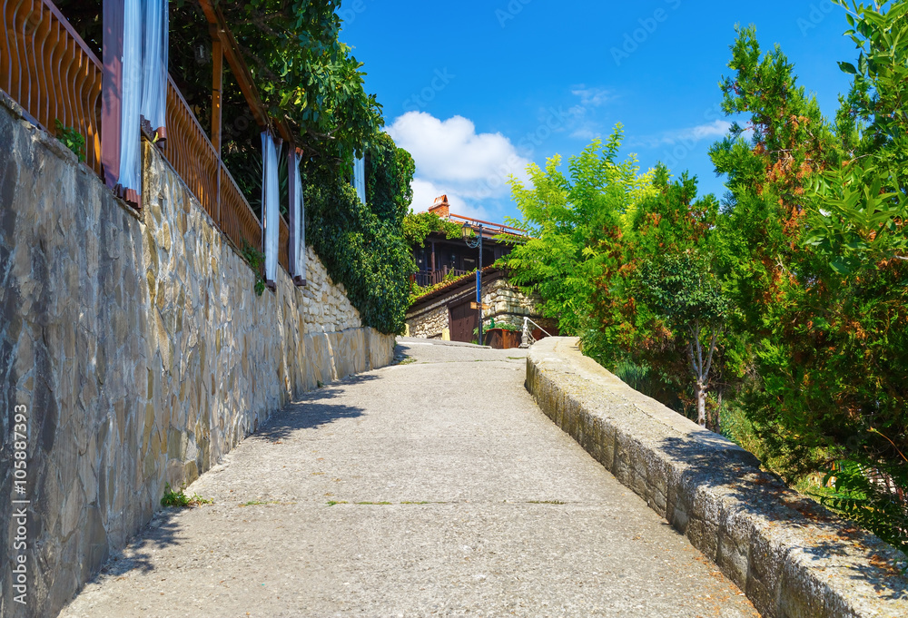 Ancient narrow street in the historic tourist town. Sidewalk in the old town of Nessebar in Bulgaria.