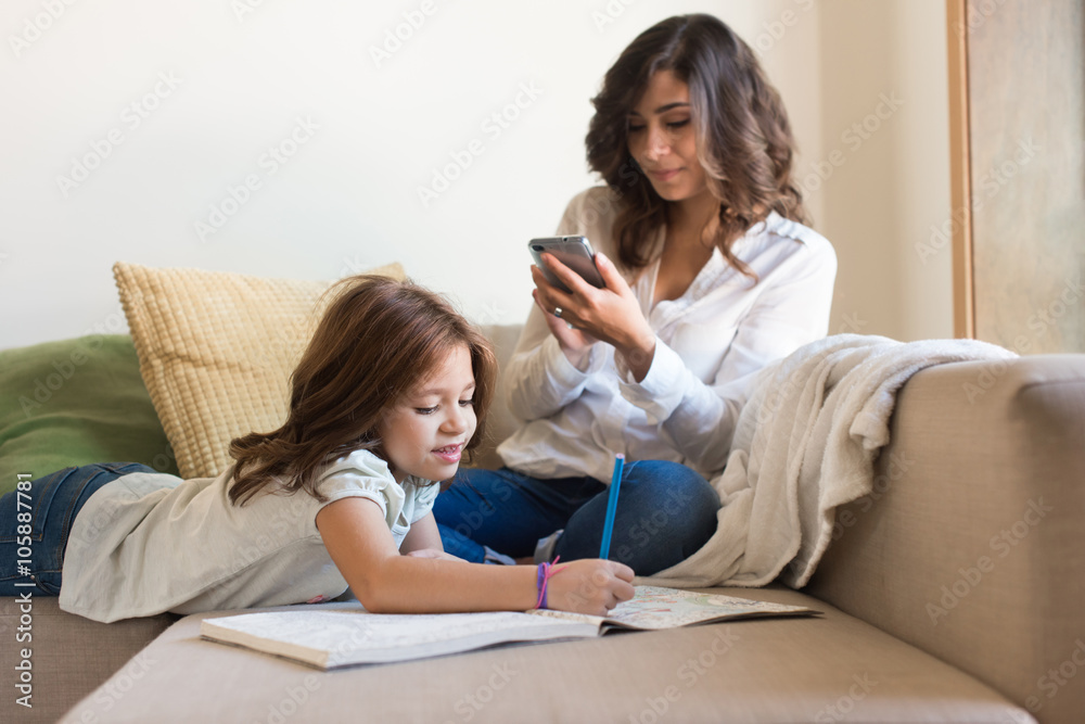 Girl painting with her mom chating Girl painting with her mom chating