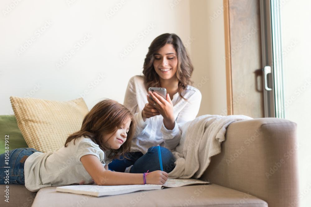 Girl painting with her mom chating
