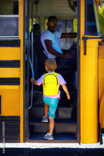 cute kid are getting on the bus, ready to go to school