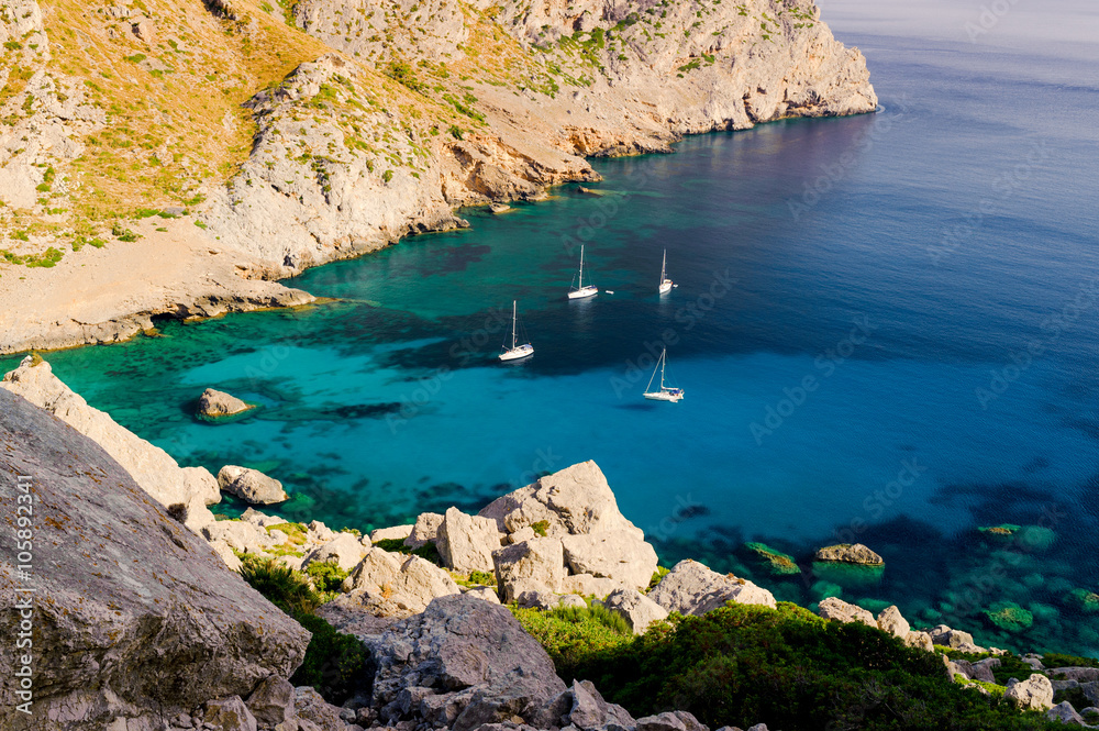 Beautiful view from Cape Formentor at bay with emerald water and small yachts. Majorca. Balearic Islands. Spain
