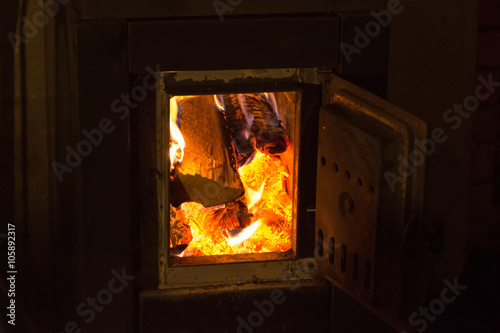 Wood burning stove. Warming cottage in winter.