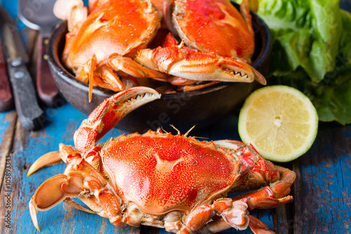 Seafood. Bowl of crabs on wooden blue background. Traditional food on Holy week Easter in Latin America. 