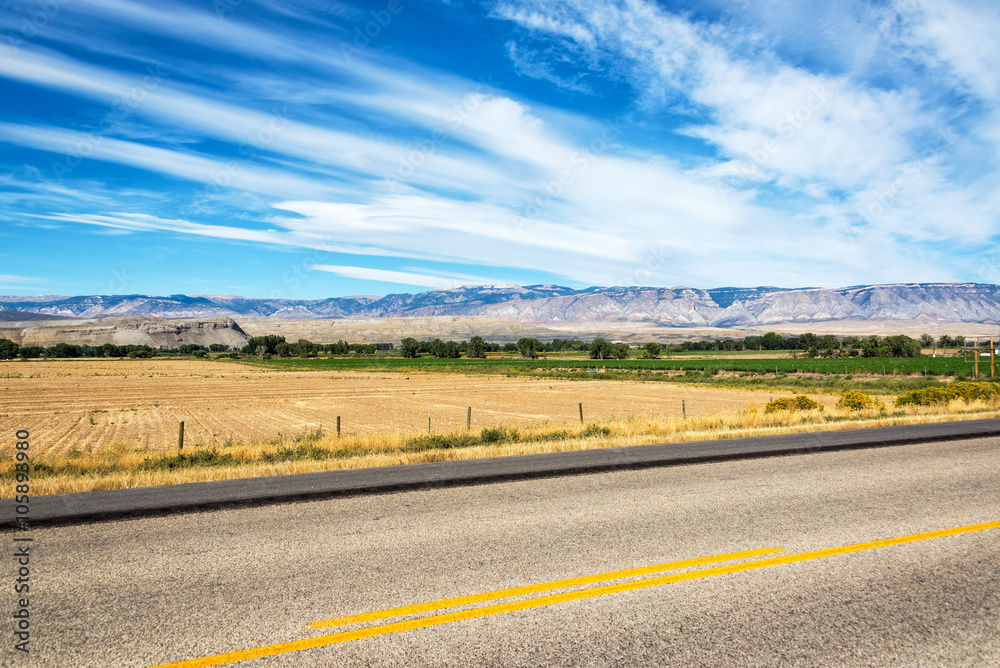 Highway passing through fields in Shell, Wyoming Highway passing through fields in Shell, Wyoming