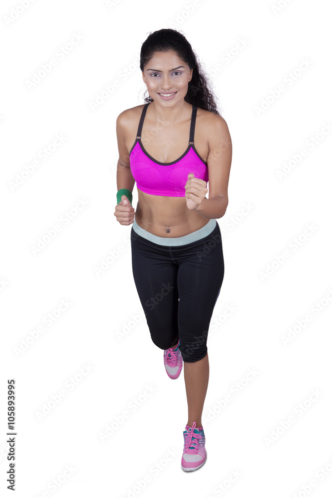 Female athlete running in studio Female athlete running in studio