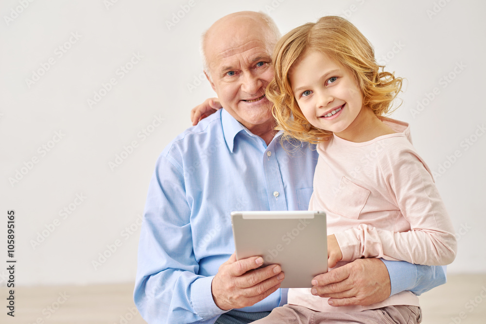 Granddaughter sitting with grandparents and table Granddaughter sitting with grandparents and table