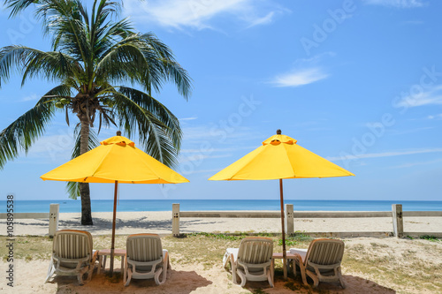Beach chairs and Yellow Umbrellas on the Bang Tao beach , Phuket in Thailand