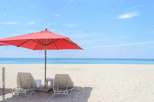 beach chair and Red Umbrella with white sand on the Bang Tao beach , Phuket in Thailand