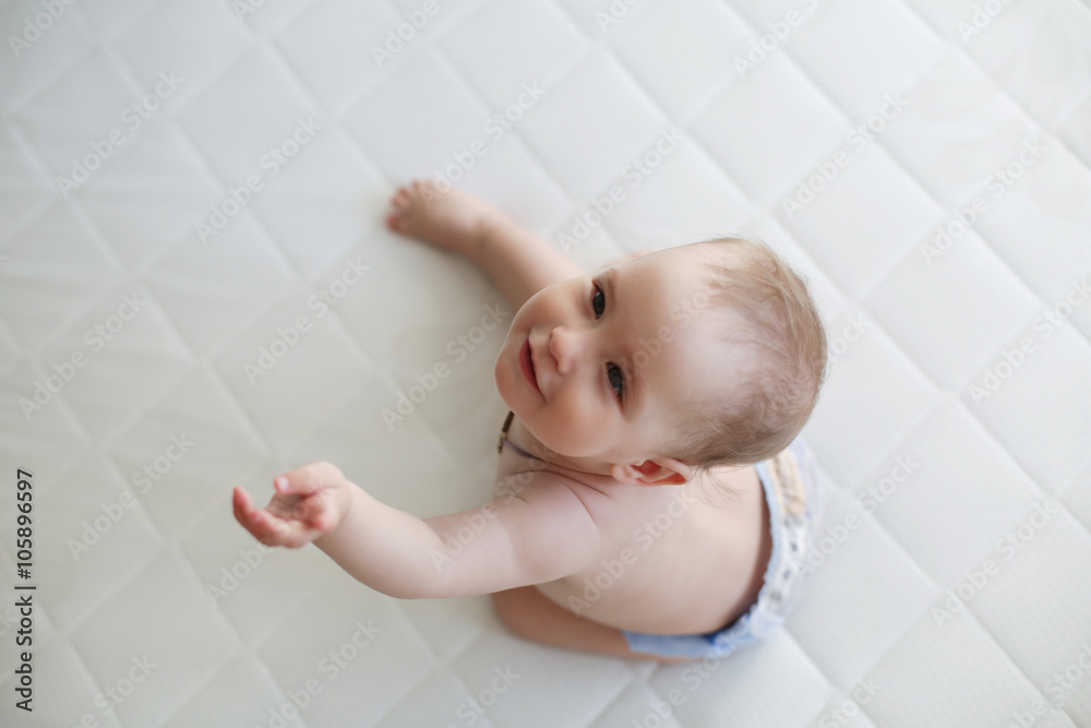 little girl in diaper on white bed little girl in diaper on white bed