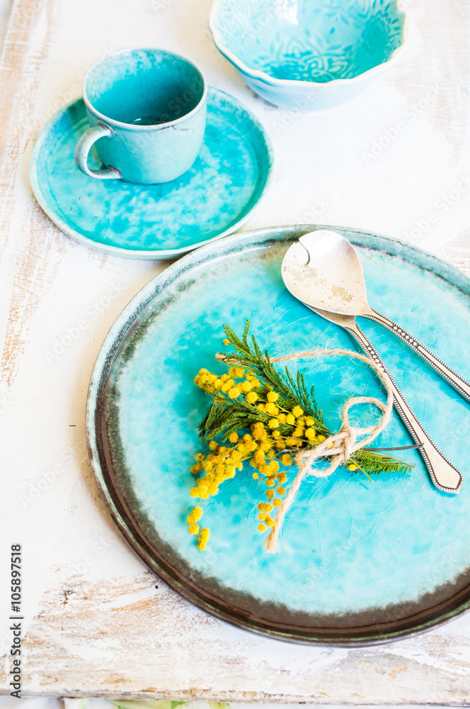 Table setting with sprig mimosa flowers Table setting with sprig mimosa flowers