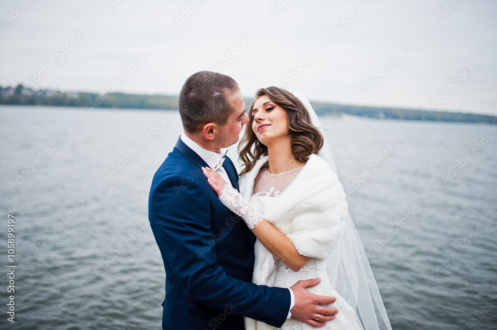 Close up wedding portrait of couple in cloudy weather on the bac Close up wedding portrait of couple in cloudy weather on the bac