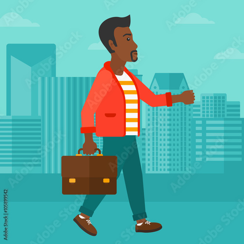 Businessman walking with briefcase. 