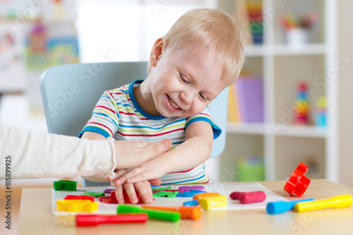 Child boy plays with clay d...