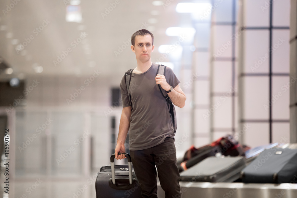 Traveller with luggage at conveyor belt Traveller with luggage at conveyor belt