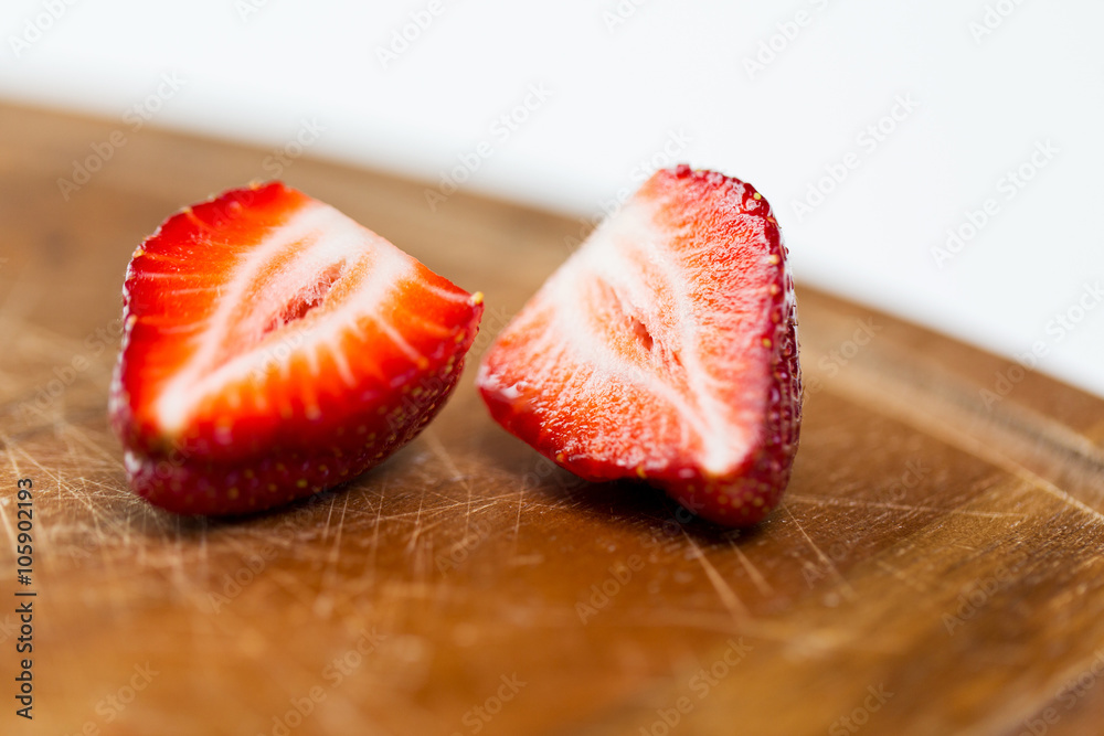 close up of ripe red strawberries on cutting board close up of ripe red strawberries on cutting board