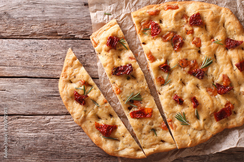 Valokuva Italian focaccia with sun-dried tomatoes. Horizontal top view