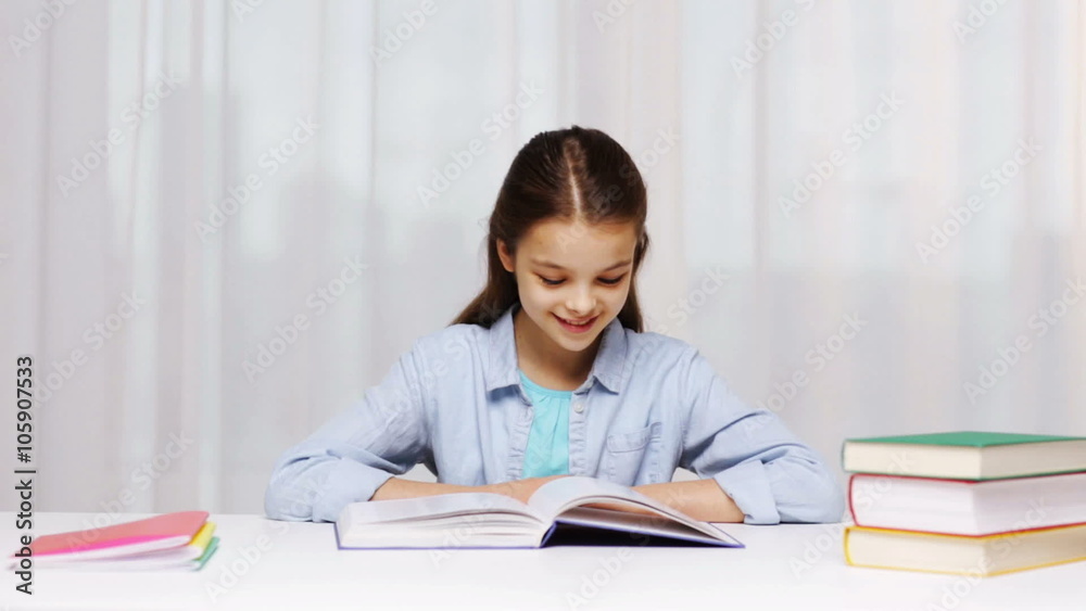 happy school girl reading book or textbook at home happy school girl reading book or textbook at home
