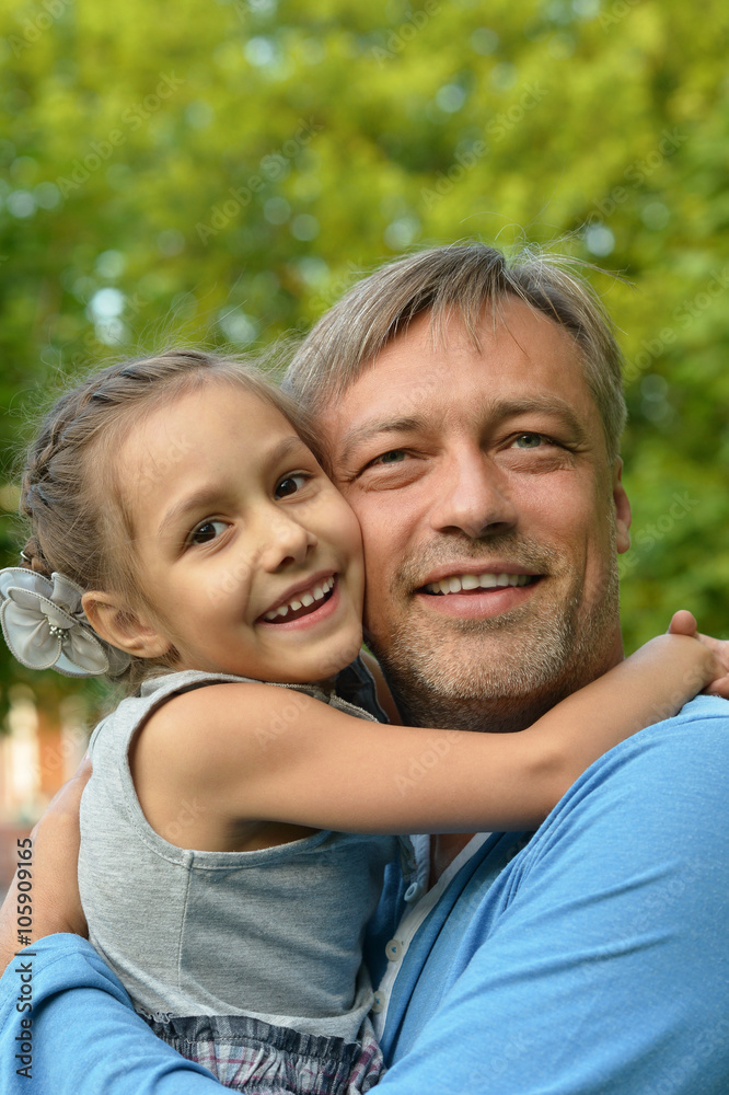father with daughter in summer park father with daughter in summer park