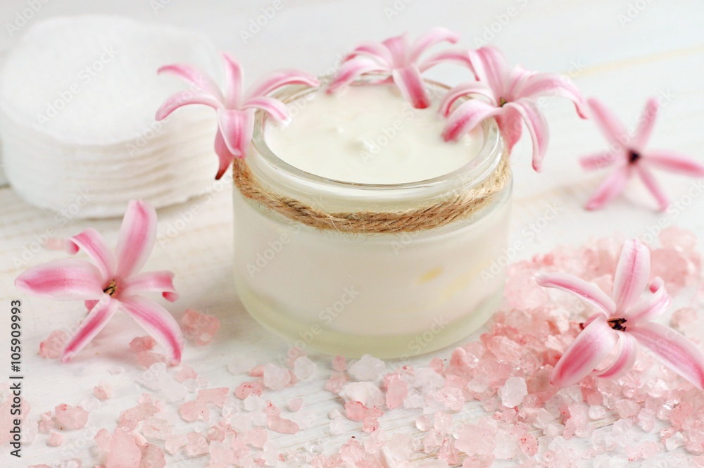 Fresh skin care cream, flowers, pink bath salt, cotton pads. Natural beauty treatment. Fresh skin care cream, flowers, pink bath salt, cotton pads. Natural beauty treatment.