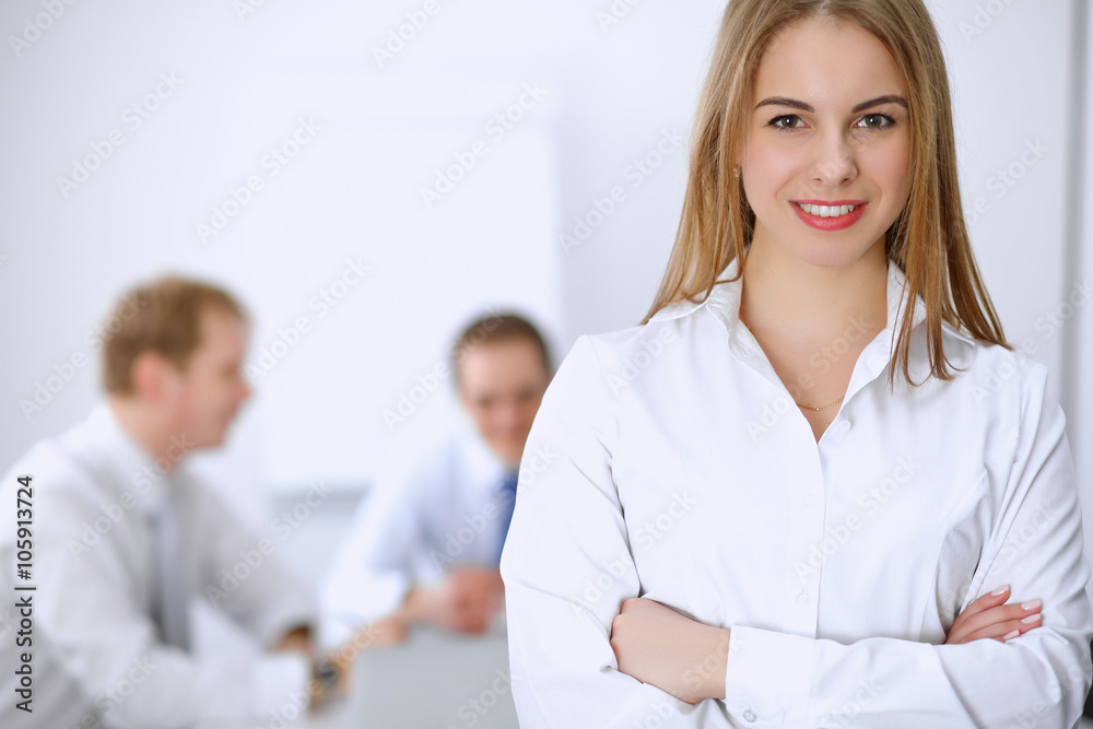 Beautiful business woman on the background of business people during meeting Beautiful business woman on the background of business people during meeting