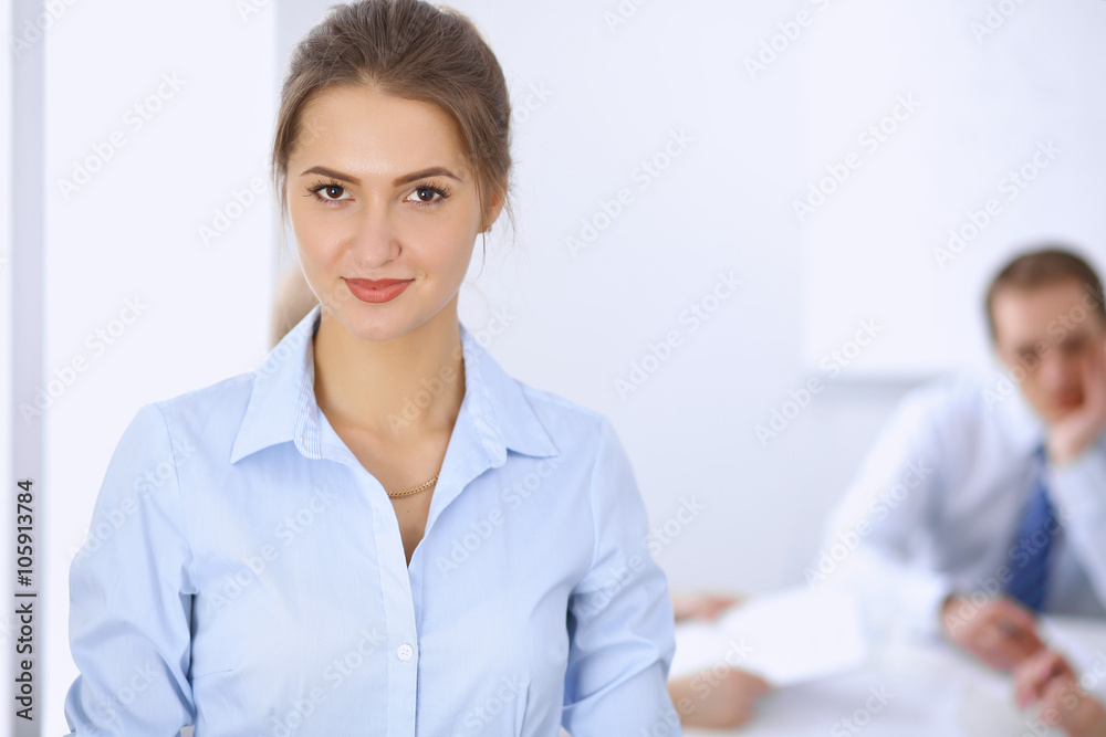 Beautiful business woman on the background of business people during meeting Beautiful business woman on the background of business people during meeting
