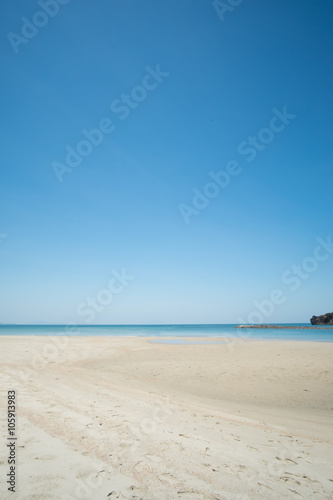 Sea and sand on the beach in blue sky.