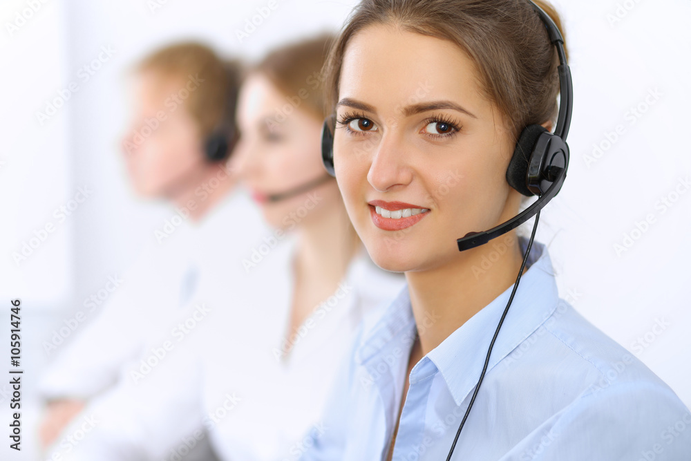 Call center. Focus on beautiful woman in headset Call center. Focus on beautiful woman in headset