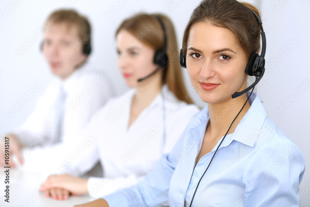 Call center. Focus on beautiful woman in headset Call center. Focus on beautiful woman in headset