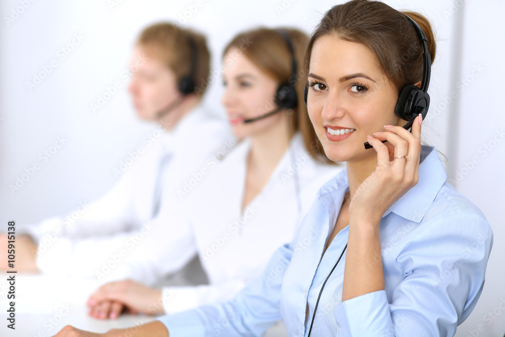 Call center. Focus on beautiful woman in headset Call center. Focus on beautiful woman in headset