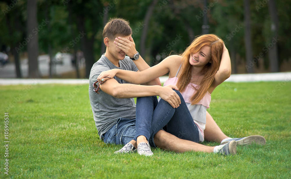 happy couple lying on the lawn