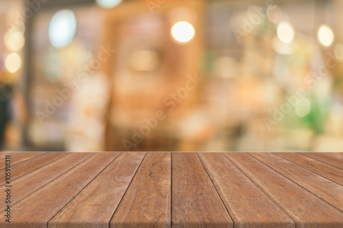 Wooden board empty table in front of blurred background. Perspective brown wood over blur in coffee shop - can be used for display or montage your products.Mock up for display of product.