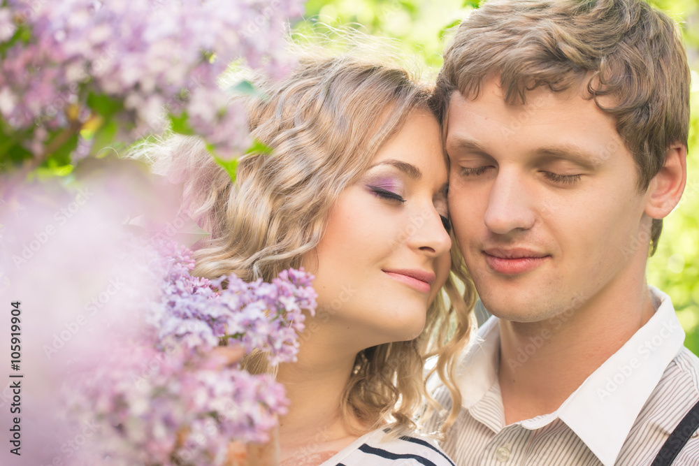 young couple near lilac tree
