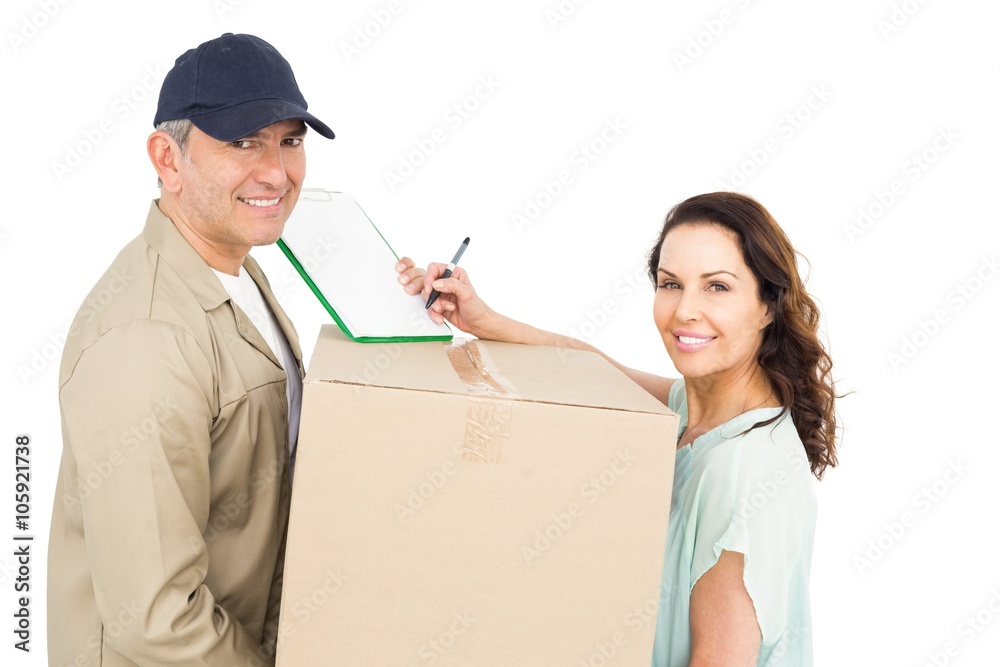 Female customer signing on paper with delivery man Female customer signing on paper with delivery man