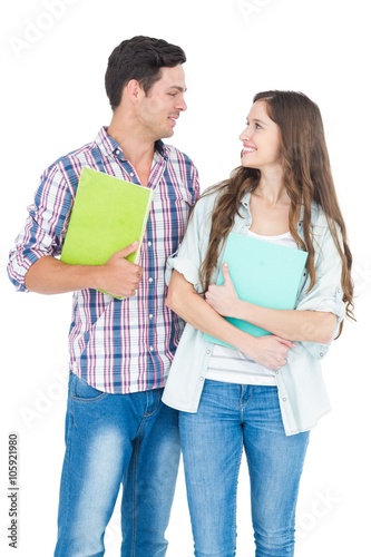 Portrait of students couple holding books 