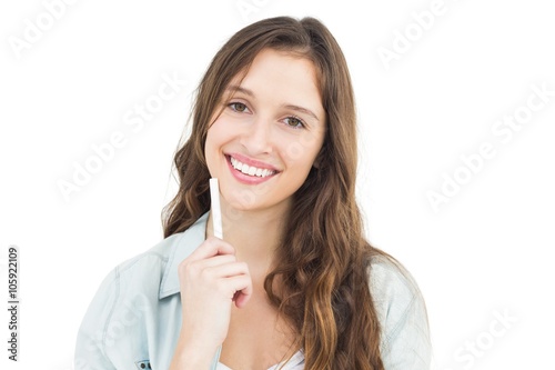 Thoughtful female student holding a chalk