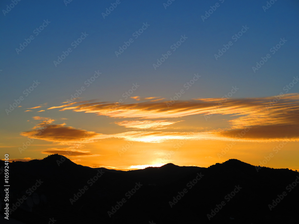 Orange sunrise over hills