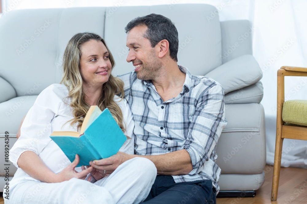 Expecting couple sitting on bed Expecting couple sitting on bed
