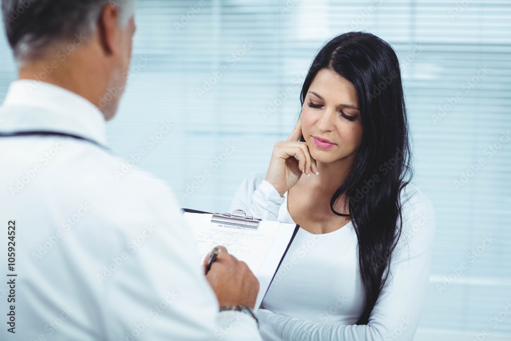 Fototapeta premium Pregnant woman interacting with doctor