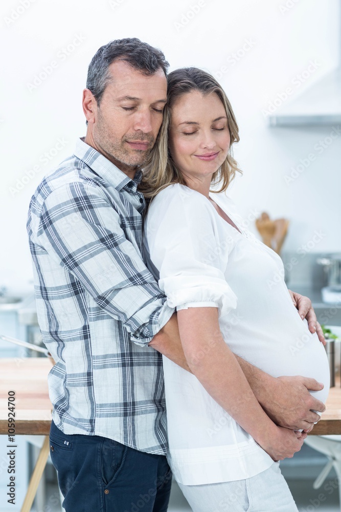 Fototapeta premium Pregnant couple in kitchen